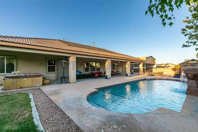 view of pool with a hot tub, a fenced in pool, and a patio