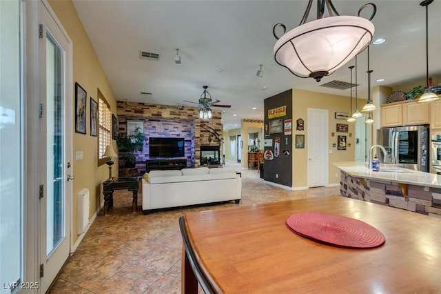 dining room with recessed lighting, visible vents, ceiling fan, and a stone fireplace