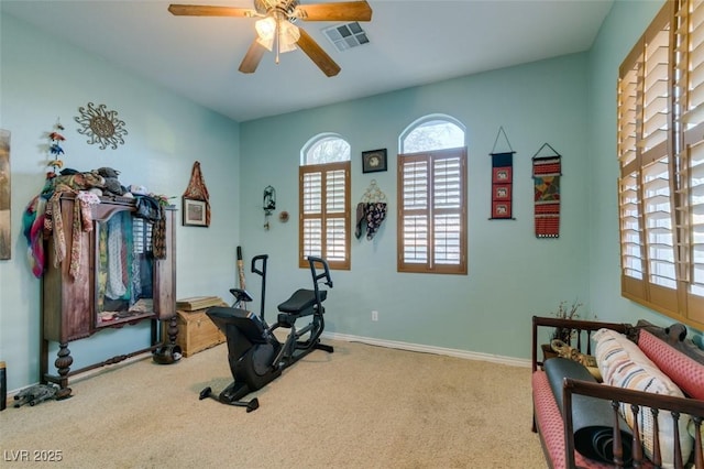 exercise area with baseboards, carpet, visible vents, and a ceiling fan