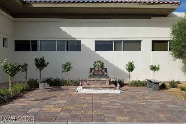 doorway to property with a patio and stucco siding