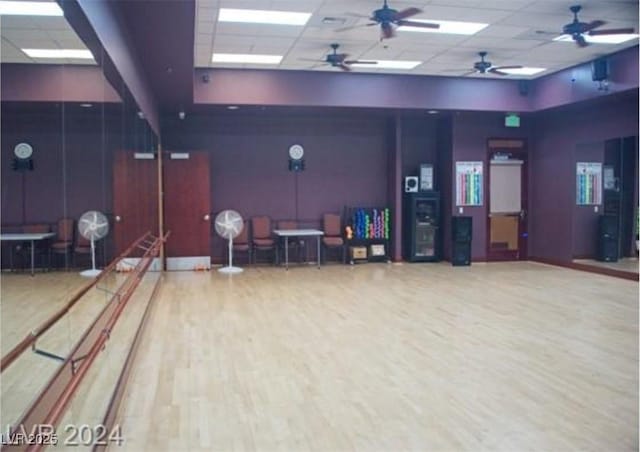 interior space featuring a paneled ceiling, bowling, and wood finished floors