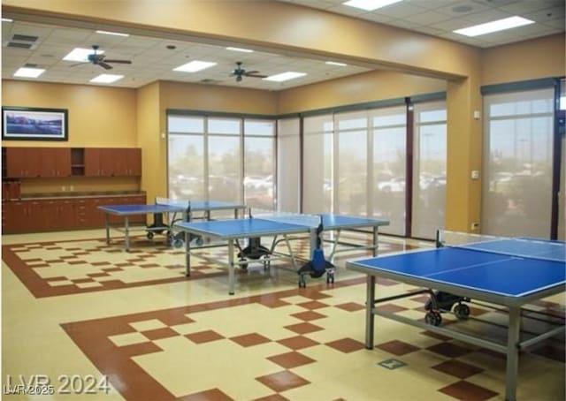 game room featuring a ceiling fan, a paneled ceiling, visible vents, and tile patterned floors