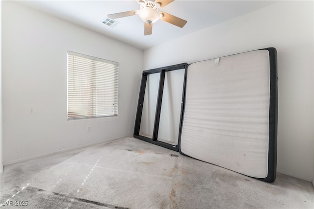 unfurnished bedroom with ceiling fan, carpet, and visible vents