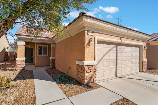 view of front of property featuring an attached garage, stone siding, driveway, and stucco siding