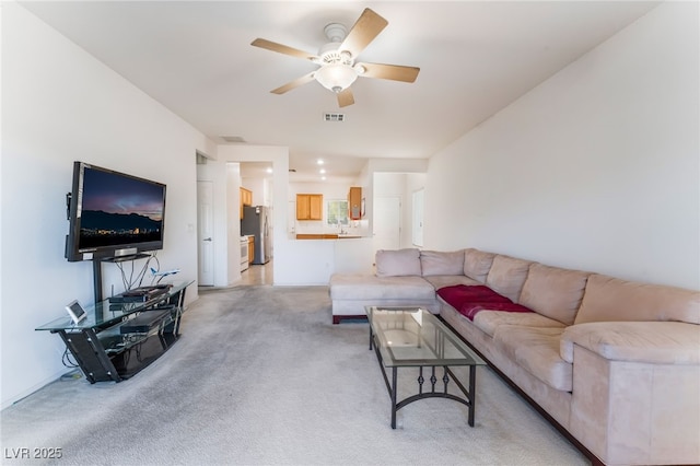 living area featuring light carpet, ceiling fan, and visible vents