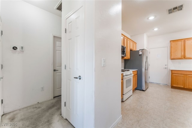 kitchen featuring light floors, recessed lighting, light countertops, visible vents, and appliances with stainless steel finishes