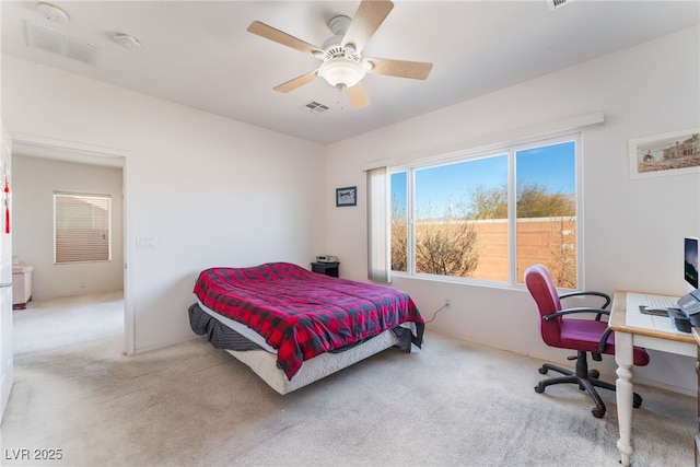 carpeted bedroom with visible vents and a ceiling fan