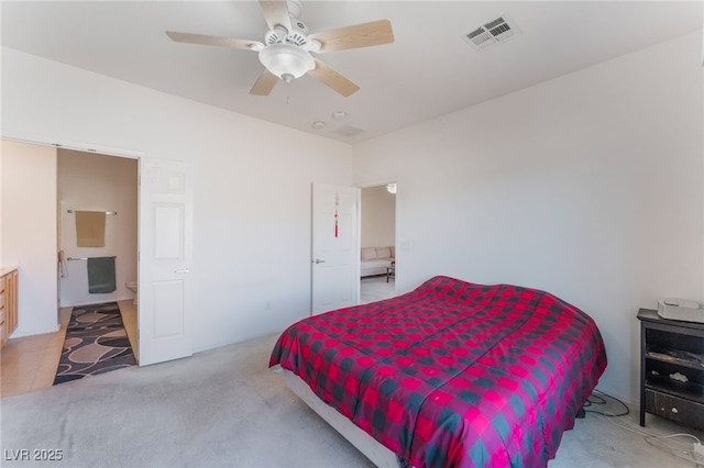 carpeted bedroom with a ceiling fan and visible vents