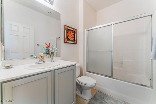 bathroom with shower / bath combination with glass door, visible vents, toilet, vanity, and tile patterned floors