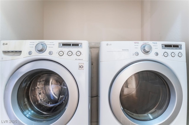 washroom with laundry area and washer and dryer