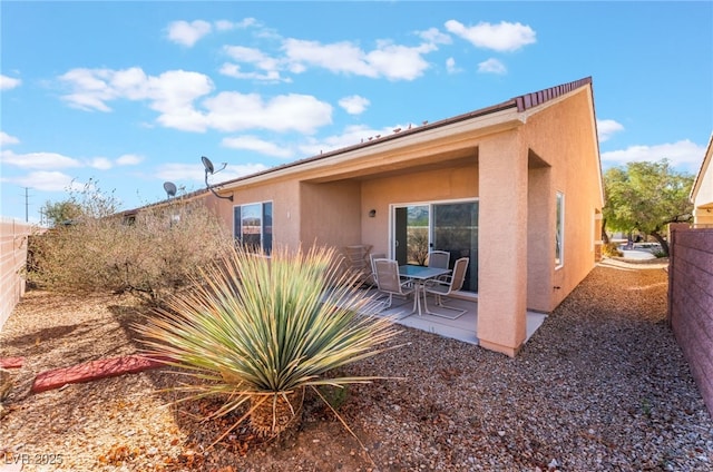 back of property with a patio area, fence, and stucco siding