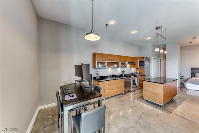 kitchen with built in appliances, concrete flooring, a sink, baseboards, and dark countertops