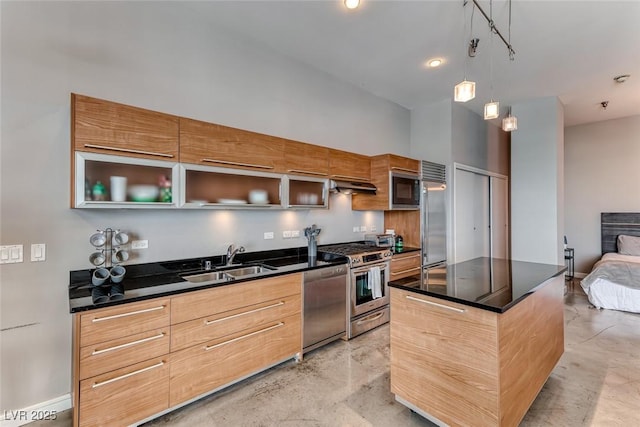 kitchen with finished concrete flooring, dark countertops, modern cabinets, built in appliances, and a sink