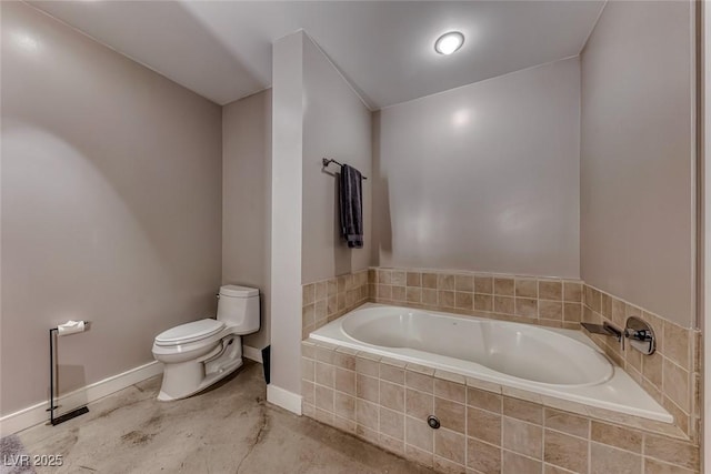 bathroom with baseboards, a garden tub, and toilet