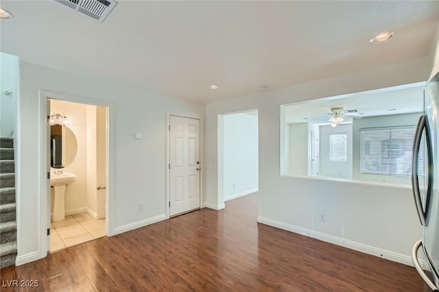 unfurnished living room with baseboards, visible vents, stairway, wood finished floors, and recessed lighting