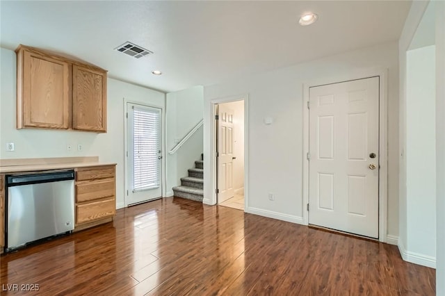 kitchen featuring baseboards, visible vents, dark wood-style flooring, light countertops, and stainless steel dishwasher