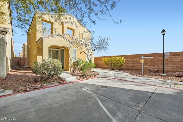 view of front of home featuring fence and stucco siding