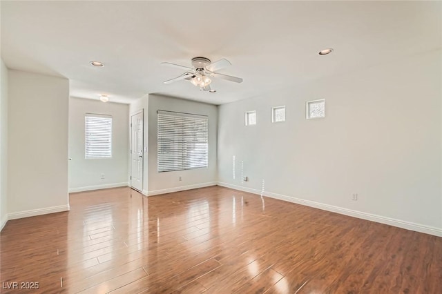 spare room featuring recessed lighting, ceiling fan, baseboards, and wood finished floors