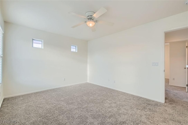 spare room with carpet floors, baseboards, and a ceiling fan