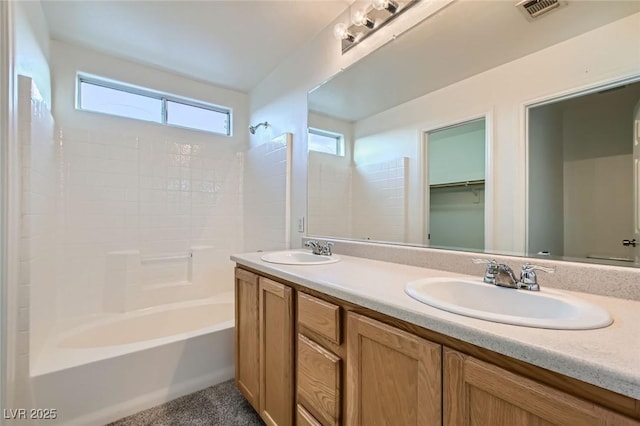 full bathroom featuring double vanity, visible vents, a sink, and bathing tub / shower combination