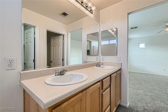 bathroom with double vanity, visible vents, and a sink