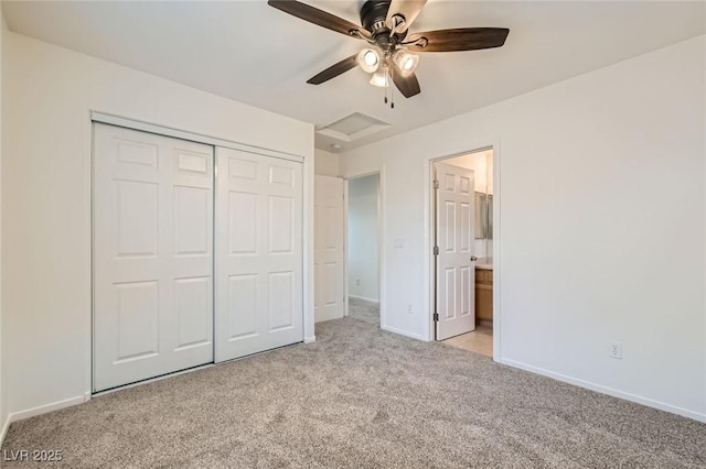 unfurnished bedroom featuring ceiling fan, light colored carpet, baseboards, a closet, and attic access