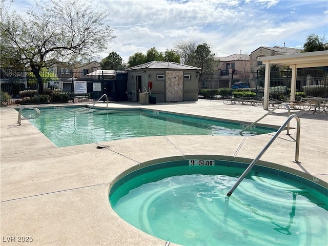 community pool with a community hot tub, a patio area, and fence