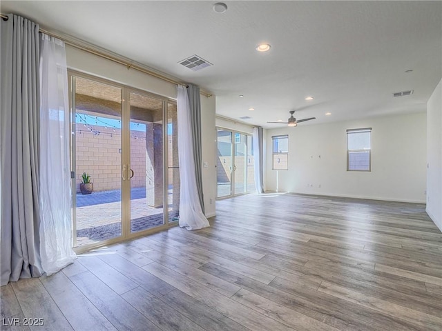 unfurnished room featuring ceiling fan, visible vents, wood finished floors, and recessed lighting