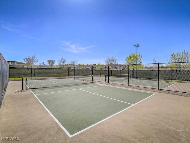 view of sport court with fence