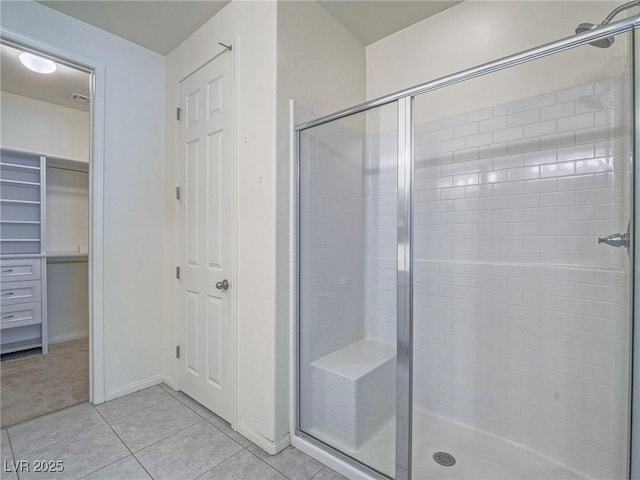 bathroom with baseboards, a shower stall, visible vents, and tile patterned floors