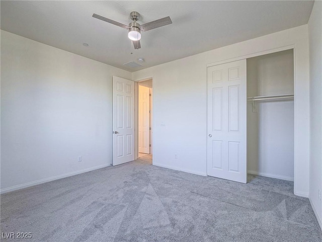 unfurnished bedroom with a closet, carpet, a ceiling fan, and baseboards