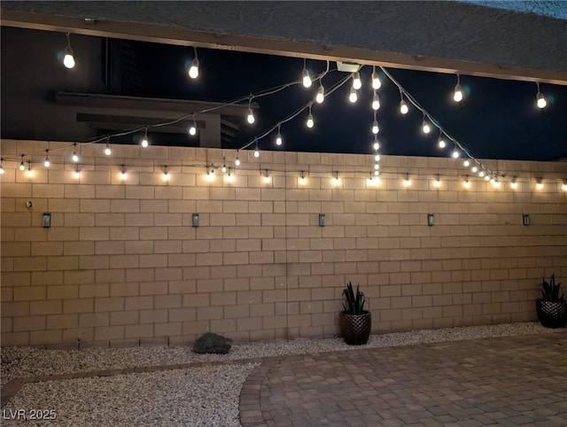 patio at night featuring fence