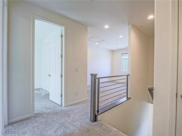 hall with recessed lighting, carpet, baseboards, and an upstairs landing