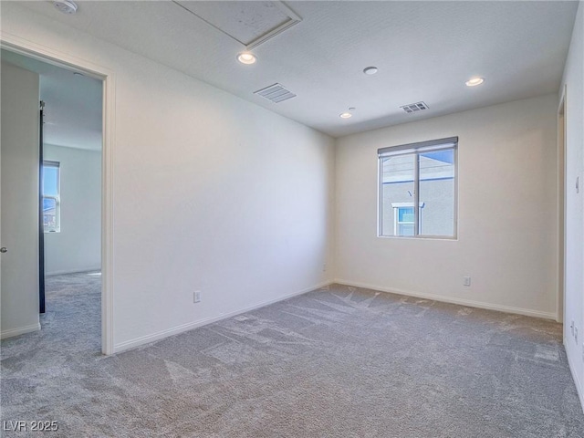 empty room with baseboards, carpet floors, visible vents, and recessed lighting