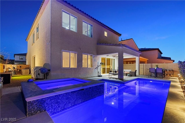 view of pool featuring a fenced in pool, a patio area, fence, and an in ground hot tub