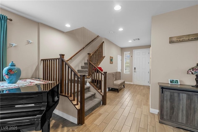 entryway with recessed lighting, visible vents, light wood-style floors, baseboards, and stairs