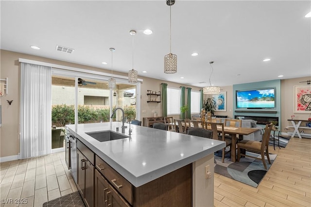 kitchen with wood tiled floor, a sink, and recessed lighting