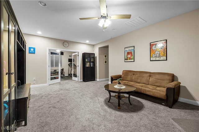 living room featuring carpet floors, visible vents, baseboards, and recessed lighting