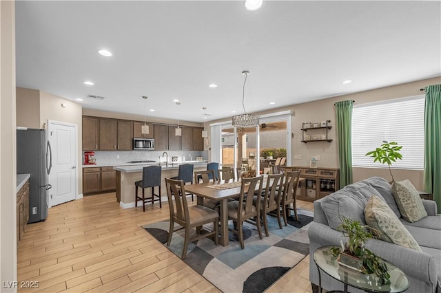 dining area featuring light wood-style floors, recessed lighting, and visible vents