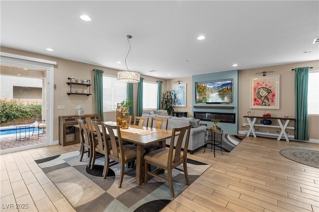 dining space featuring light wood-style flooring, a wealth of natural light, and recessed lighting