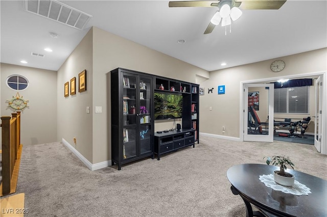 carpeted living area with recessed lighting, visible vents, and baseboards