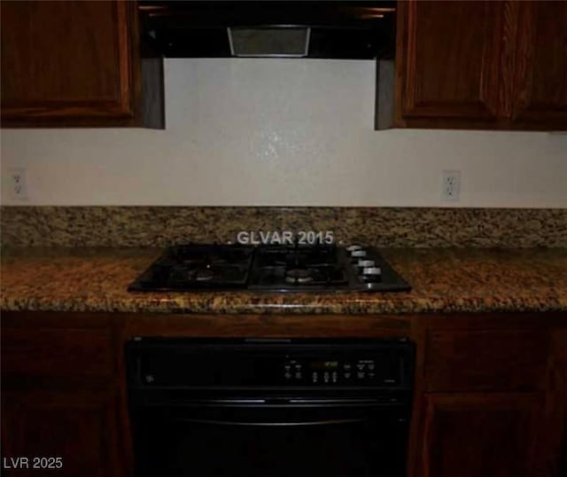 kitchen with dark brown cabinetry, black appliances, and exhaust hood