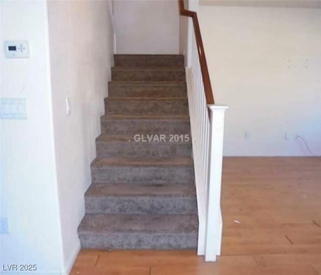 stairway featuring wood finished floors