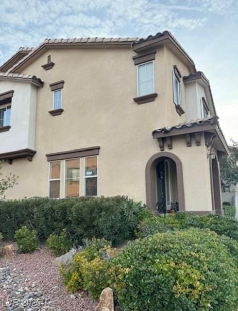 rear view of property with stucco siding