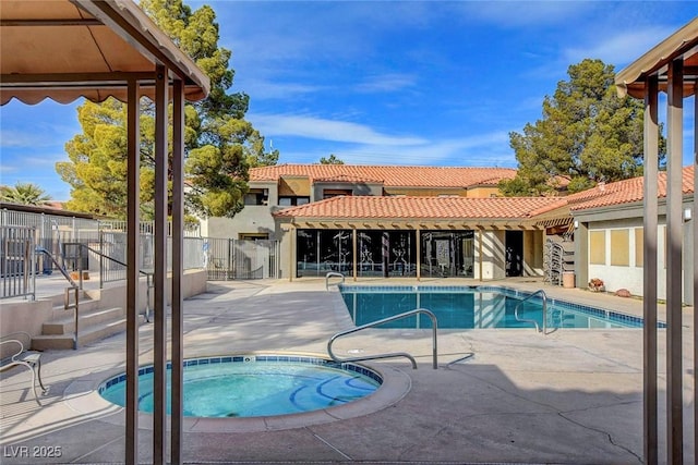 community pool featuring fence, a community hot tub, and a patio