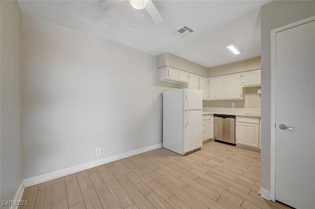 kitchen with visible vents, dishwasher, light wood-style flooring, freestanding refrigerator, and light countertops