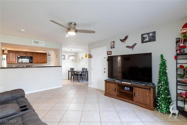 living room featuring visible vents, ceiling fan, baseboards, and light tile patterned flooring