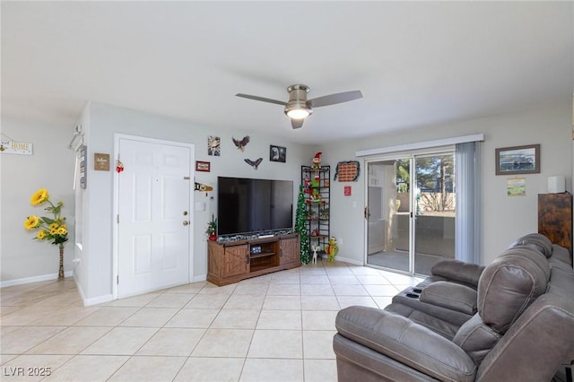 living room featuring light tile patterned floors, baseboards, and a ceiling fan