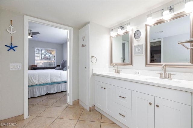 ensuite bathroom featuring double vanity, a sink, ensuite bathroom, and tile patterned floors