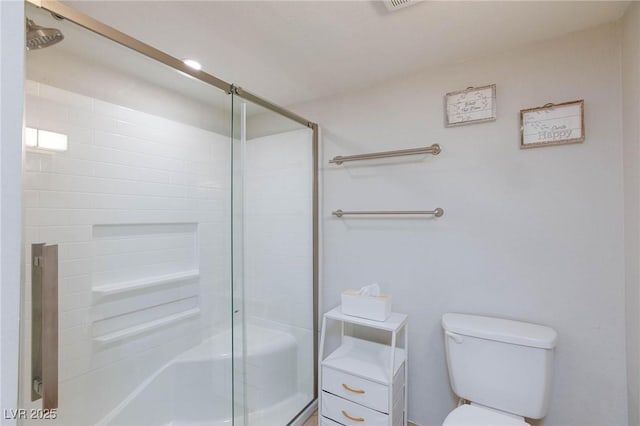 bathroom with toilet and a shower stall